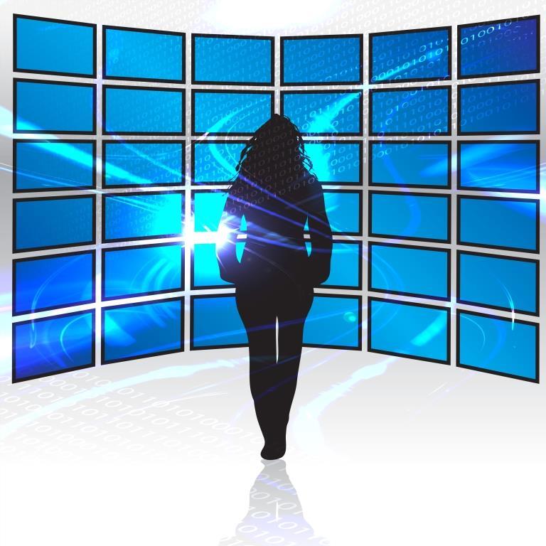 a-silhouette-of-a-woman-standing-in-front-of-a-wall-of-tv-screens_SF-xi-dRHs.jpg